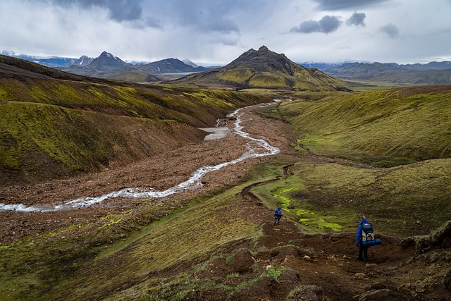 rugged mountain landscape with a meandering stream cutting through the valley.