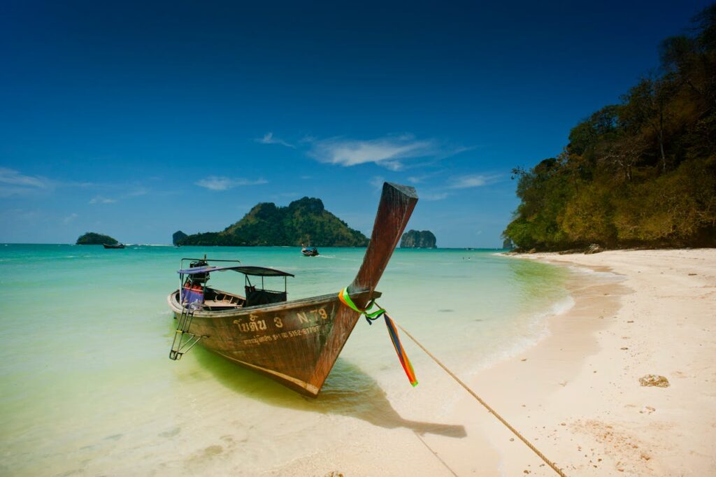 brown wooden boat beside a body of water